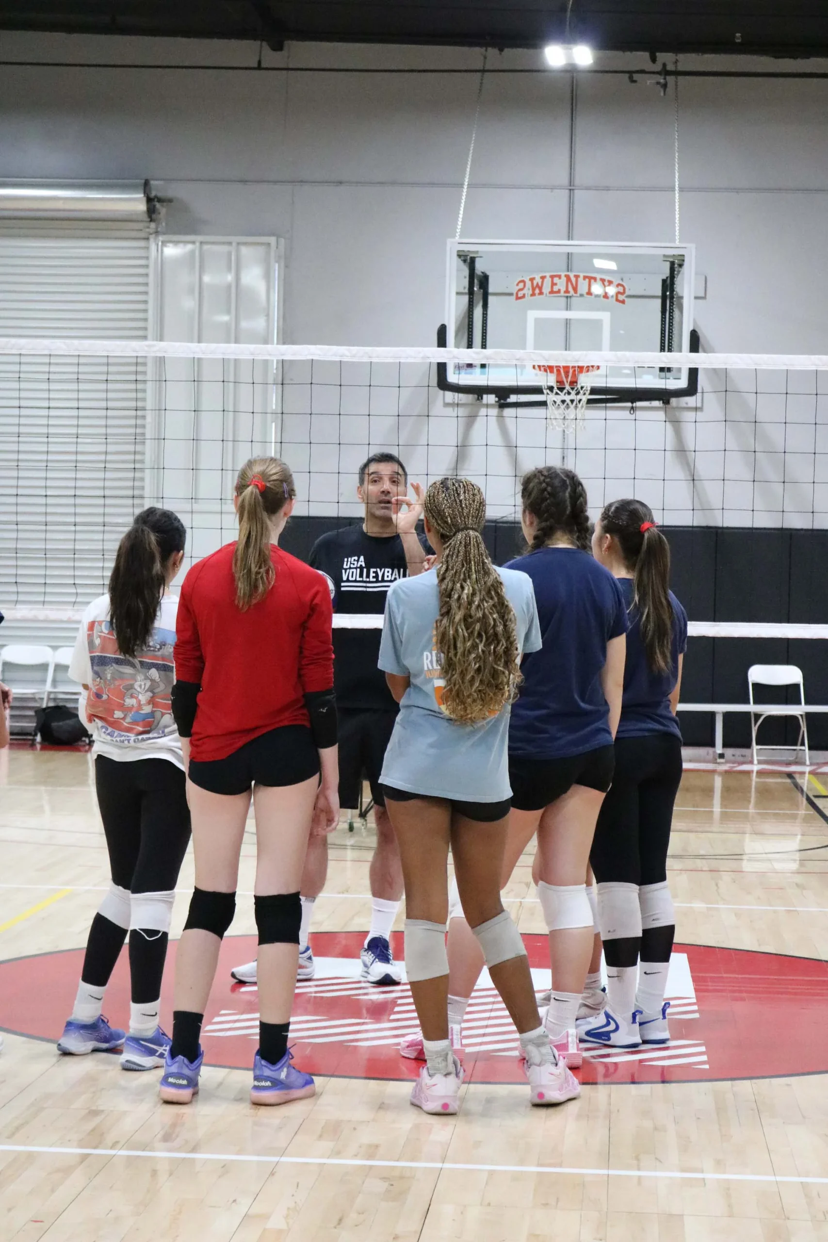 OCVA summer volleyball camp warm-up drills in Lake Forest indoor gym