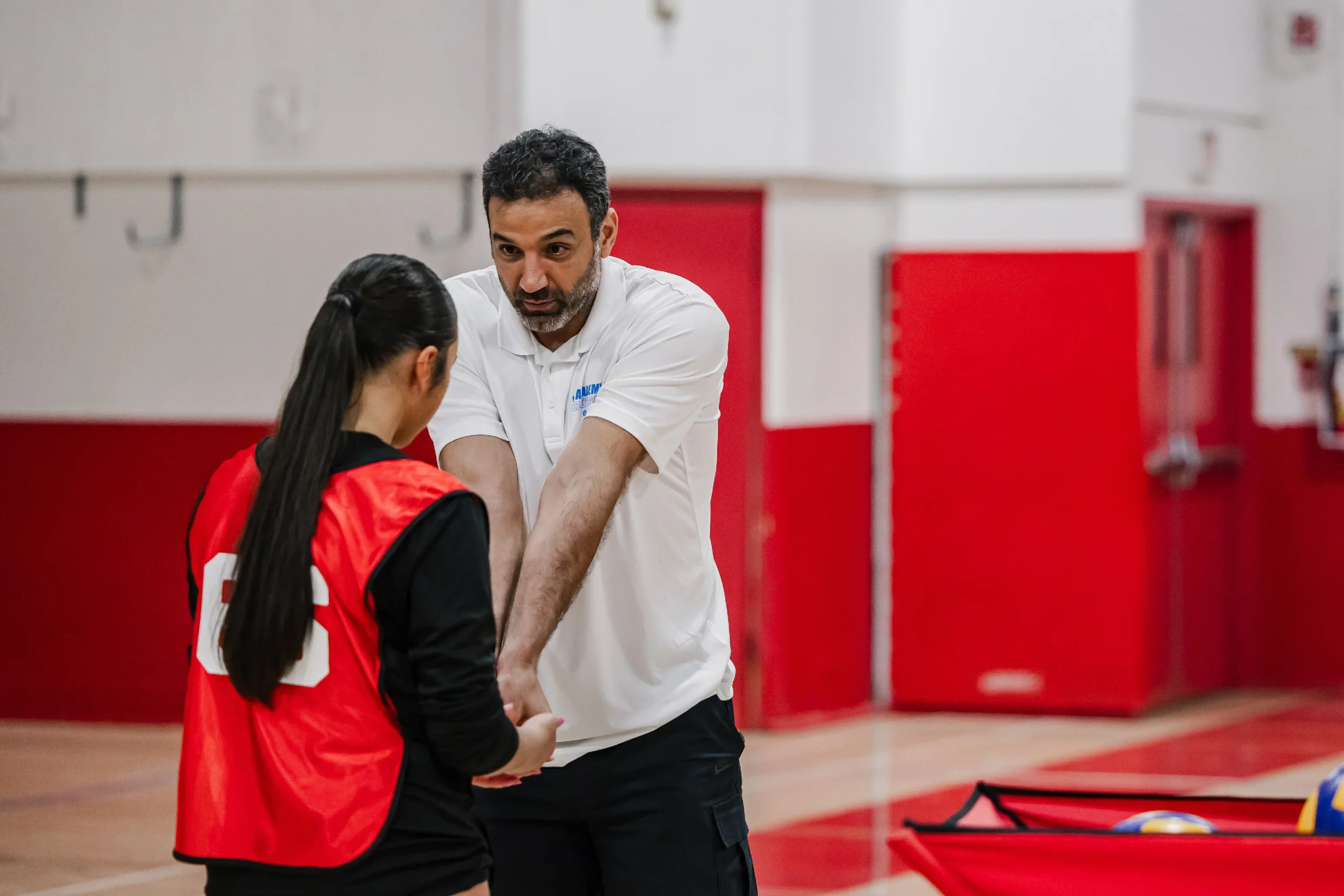 OCVA coach providing one-on-one youth volleyball training feedback